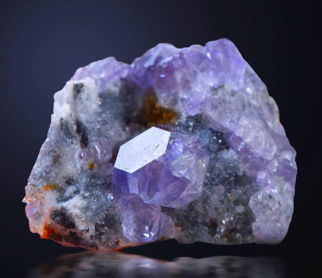 Fluorite, amethyst, and quartz crystal specimens displayed together